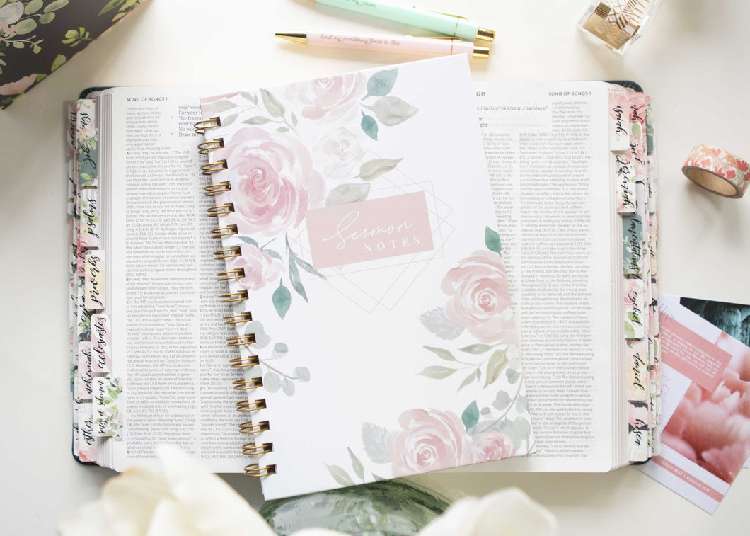 white-Sermon-Notebook-for-Church-notes-has-pink-floral-design-laying-on-NET-Bible-with-pink-floral-bible-tabs